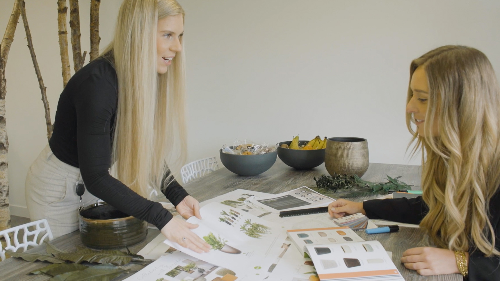  Employees working happily in a plant-filled office.